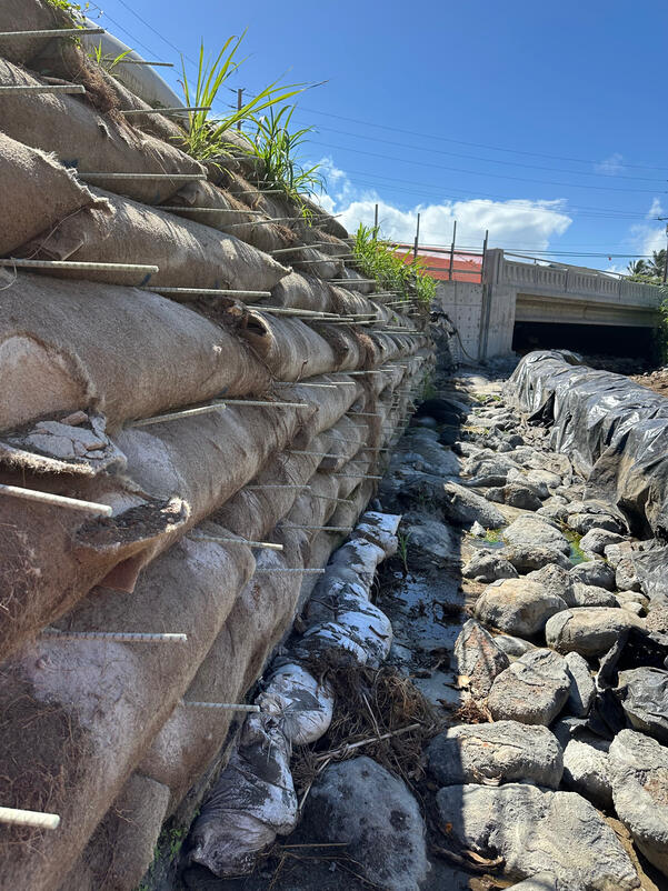 Reinforced embankment and drainage channel leading to Hauula Bridge