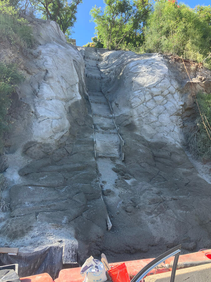 Sculpted concrete slope and central channel at the Board of Water Supply project