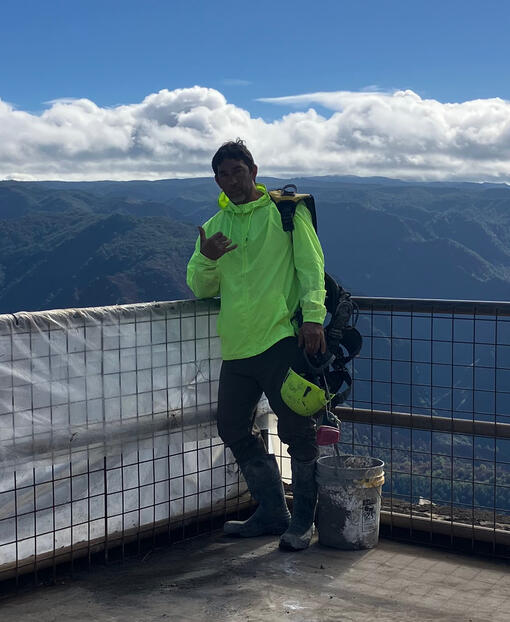 Isaac Brumaghim at a job site overlooking a Hawaiian valley
