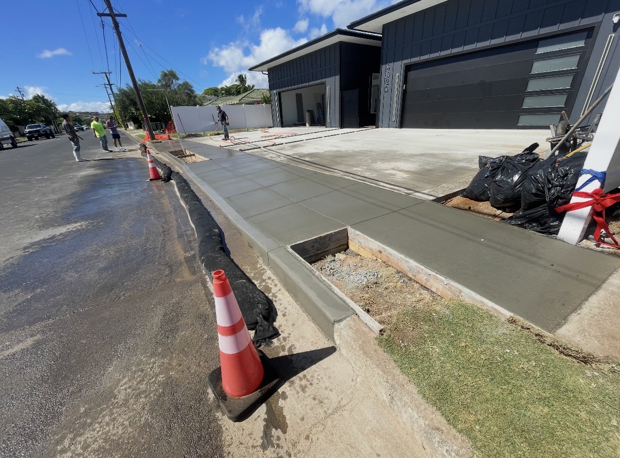 New concrete driveway, sidewalk and apron in front of two garages