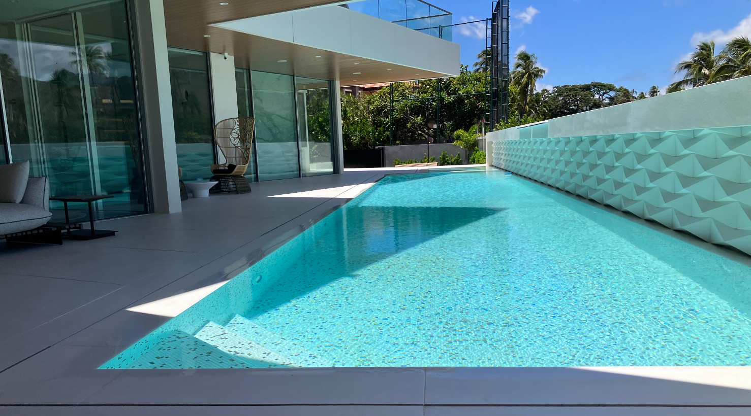 Finished blue-tiled swimming pool at a modern home in Hawaii